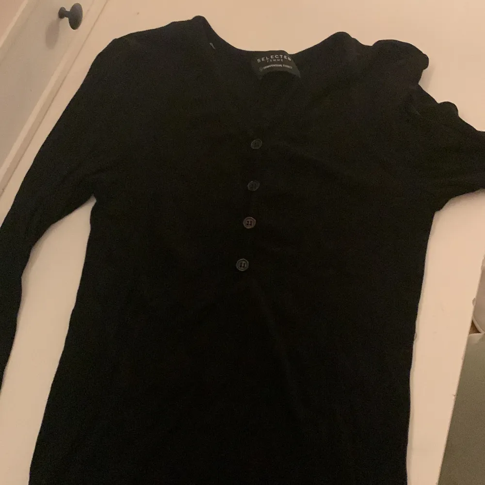 En helt vanlig svart tröja med lite knappar i stretch material. Pris kan diskuteras. Tröjor & Koftor.