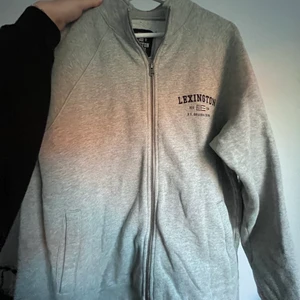 Lexington zip hoodie - En grå jättefin zip hoodie (utan luva), som har en lite högre krage samt fickor på båda sidor. (herr modell, men passar dam!)