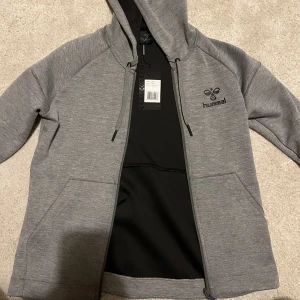 Hummel kofta  - En helt ny hummel kofta med lapp kvar. Härlig grå färg med tummhål i armarna och ett jätteskönt mjukt material! Perfekt för t.ex en löprunda eller bara till vardags 🥰 i strl Xs men passar även s 💖