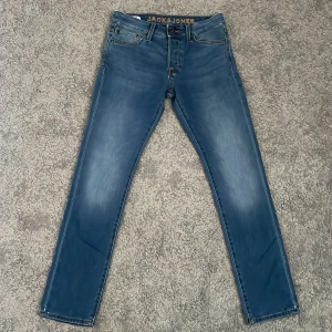 Blå slim jeans Jack & Jones 29/30 - Snygga blå skinny jeans från Jack & Jones, modell Glenn. Jeansen är i stretchigt denim med klassisk femficksdesign och subtila slitningar. Midjan är normal och passformen är tight hela vägen ner. Perfekta för dig som gillar en modern och smal siluett. Använt 2 gånger!