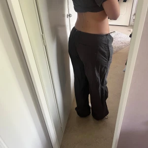 Svarta loose cargopants med snörning - Säljer ett par svarta cargopants med loose fit och dragsko i midjan och vid benslut. Byxorna har raka ben och praktiska fickor baktill. Använda men i bra skick. Nypris: 699! Tvek inte att höra av dig om du har funderingar☺️Passar även för de som brukar ha storlek S