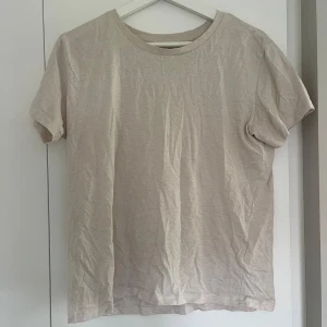 Beige t-shirt från 157 i S - En enkel och clean beige t-shirt från 157 i storlek S. T-shirten har rund hals och korta ärmar, tillverkad i mjuk mix av 80% ekologisk bomull och 20% polyester🤍🤍🤍
