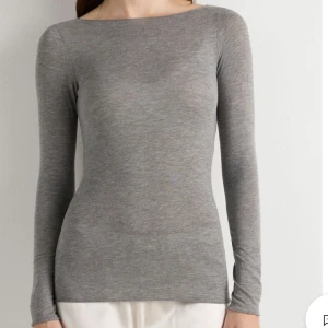grå intimissimi  - Slimmad grå långärmad topp med rund halsringning och mjukt, stretchigt material. Perfekt att styla med jeans eller kjol för en clean och enkel look aldrig använd pris går att diskutera 