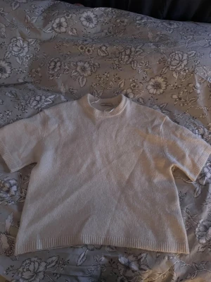 Vit stickad topp med kort ärm - Säljer en beige stickad topp med korta ärmar från Gina💕