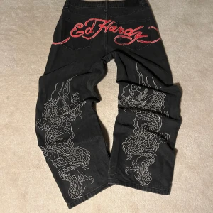Baggy Ed hardy jeans  - Ed Hardy jeans använts 3 gånger Det står att storleken är S men eftersom de är så stora passar jeansen större också   Benöppning- 26cm Midja mätt platt- 40cm Innerbenslängd- 73.5 cm Hela längden- 104.5cm Grenmått- 32cm  