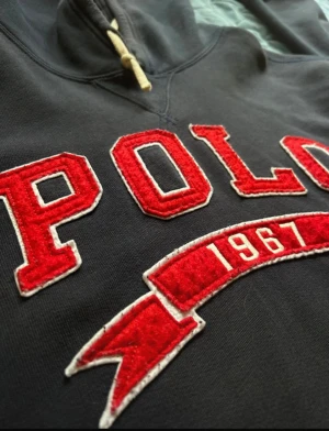 Polo Ralph Lauren hoodie - En riktigt snygg och ovanlig Ralph lauren hoodie med en broderad patch, inga defekter. Storleken är xl men passar L alla dagar i veckan eftersom den har krympt.