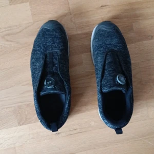 Solid Gear svarta skyddsskor med BOA-snörning - Svarta skyddskor från Solid Gear i storlek 45 med stickad ovandel och BOA-snörningssystem för enkel justering. Skorna har en platt sula och sportig design, perfekta för dig som gillar stilrena och funktionella skor. Materialet är syntet och textil. Skydd vid tårna om man tappar något. Arbet skor.