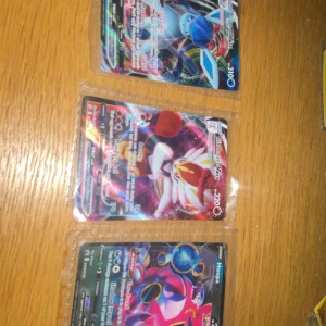 Pokémon VMAX Specialkort (Glaceon, Cinderace, Hoopa, Talonflame) - Samling av coola Pokémon VMAX specialkort, perfekt för dig som älskar att samla och spela Pokémon TCG! Färgstarka och glittriga kort med populära Pokémon som Glaceon, Cinderace, Hoopa och Talonflame. Ett måste för fans och unga samlare som vill ha något extra i sin kortlek.
