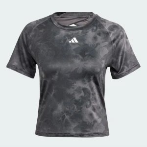 Svart tränings-topp från Adidas - Cool svart tränings-topp från Adidas med mönster och vit logga framtill. Toppen är croppad, har korta ärmar och en öppen rygg med snygg detalj. Använd en gång. 