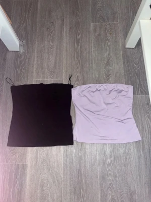två st tubtoppar - Säljer två st tub toppar. Svarta ribbad strl M från H&M. Den syrenlila strl Xs från shein.