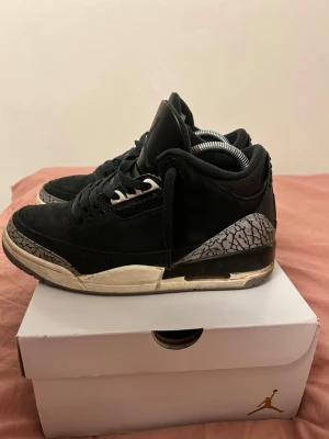 Svarta Nike Jordan 3 sneakers - Nike Air Jordan 3 sneakers i svart med klassiskt elephant print i grått på tå och häl. Skorna har snörning, rund tå och platt sula. Ovandelen är i skinn och textil, med Jumpman-logga på plösen. Perfekt för dig som gillar streetwear och ikoniska sneakers. ( box ingår) 📦