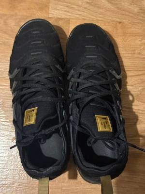 Nike Air Vapormax Plus – storlek 44 - Säljer ett par Nike Air Vapormax Plus i storlek 44. Skorna är använda men fortfarande i okej skick. Det finns tydliga spår av slitage, bland annat på sulan (se bilder), men annars är de hela och funkar bra för fortsatt användning.  Perfekta om du vill ha ett par bekväma sneakers till vardag eller träning utan att behöva köpa helt nya.