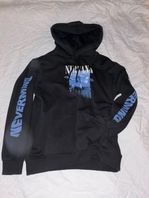 Svart/blå nirvana hoodie - En skön och stilren svår hoodie ifrån H&M med Nirvana inspiration. Perfekt för dig som gillar Nirvana eller dig som gillar stilrena tröjor!