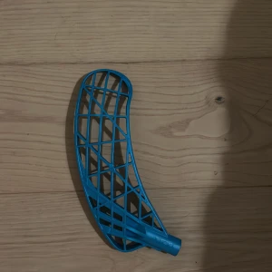 Blå innebandyklubba blad - Säljer ett blått innebandyklubba blad från Zone. Bladet är i plast och har en modern, lätt konstruktion med förstärkta ribbor för extra hållbarhet. Skicket är mycket bra, inga synliga sprickor eller skador. Perfekt för dig som vill uppgradera din klubba. Zone air one 