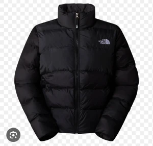 Svart pufferjacka från The North Face - Säljer en svart pufferjacka från The North Face med hög krage och tydlig logga på bröstet. Jackan har en rak passform, lång ärm och dragkedja framtill. Perfekt för kalla dagar när du vill hålla värmen och ändå se chill ut.    Storlek S