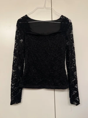 Svart spetsblus med blommönster - Säljer min oanvända blus i svart spets med blommigt mönster. Ärmarna är lite transparanta som blir superfint när den sitter på, köpte den helt ny men kom inte till användning. Hör av er om fler bilder när den sitter på eller annat ❤️