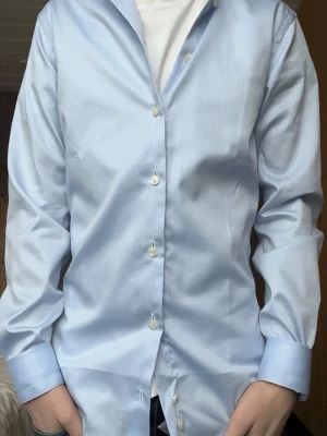 Ljusblå skjorta - Säljer en ljusblå skjorta från eton. Helt nytt skick till ett bra pris. Säljer pga att den inte kommer till användning. Nypris 1799 kr!