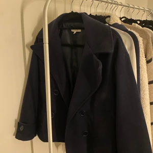 Marinblå kappa - Snygg marinblå kappa från Design by Si. Använd vid högst fem tillfällen så den är i jättebra skick. Köpt för 800kr och säljer för 400. Ställ jättegärna frågor vid funderingar❣️