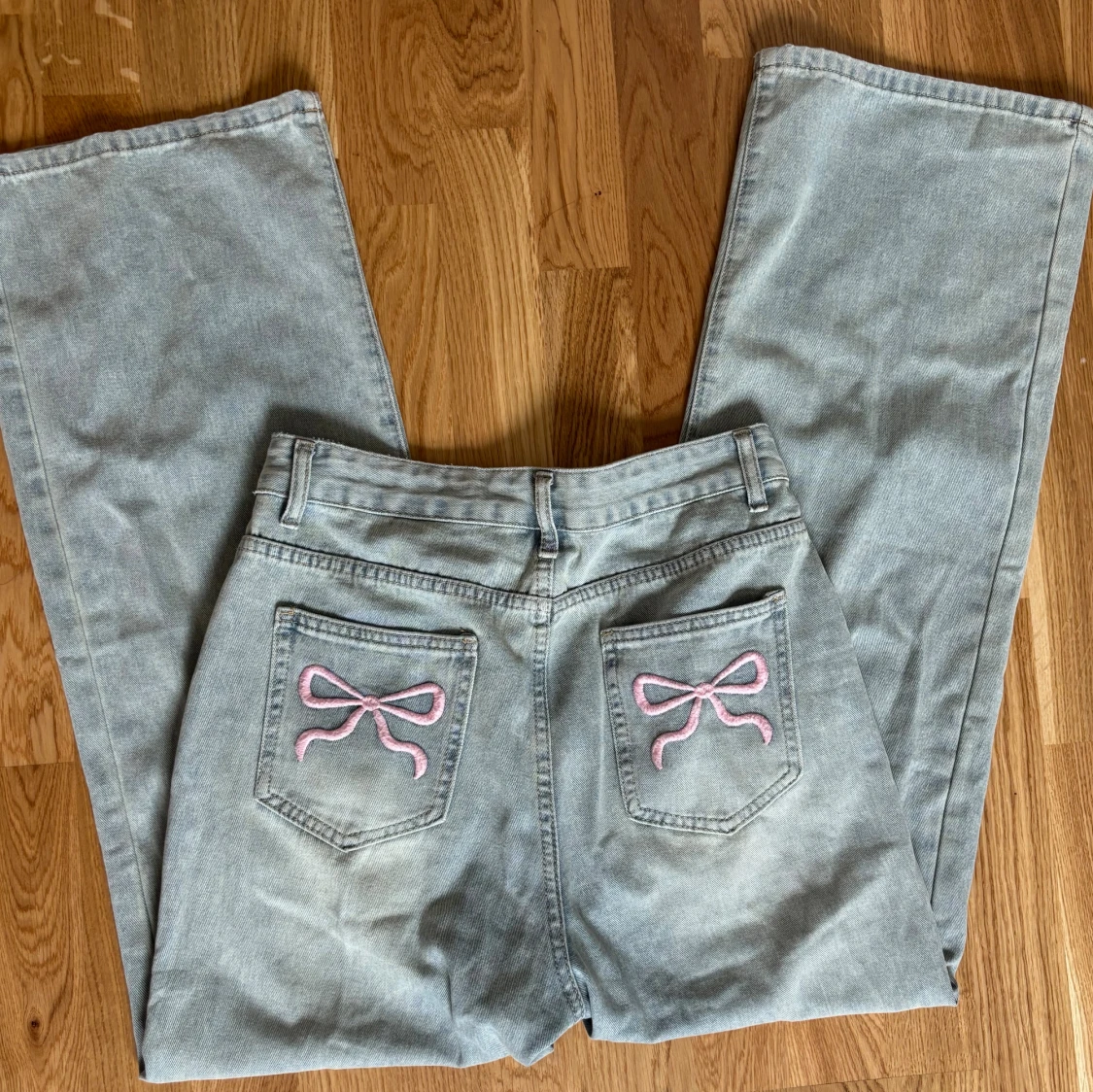 Ljusblåa jeans med rosa rosetter - 1