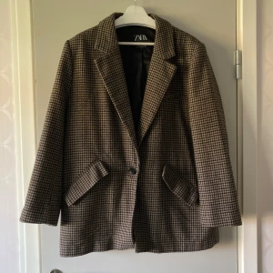 Rutig Kavaj Zara - Brun rutig kavaj från Zara. Storlek XL (dam). Super fin. Har en knapp i fram och två fickor. Säljer för 200 kr + frakt (köpare står för frakt) 💕