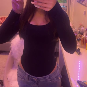 Svart långärmad slim topp - Säljer en svart långärmad topp med slim passform och rundad hals. Toppen är enkel och stilren, perfekt att matcha med jeans eller kjol. Väldigt fin och har inga skador, även använd fåtal gånger då den sitter för tajt på mig. Säljer för 100 men pris kan diskuteras 