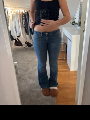 Blå bootcut jeans från ONLY S/30 - Säljer ett par klassiska blå jeans från ONLY i modellen bootcut. Jeansen har låg midja, fem fickor och snygga kontrastsömmar. Materialet är mjukt jeans-tyg som sitter skönt och följer kroppen. Perfekta till sneakers eller boots.