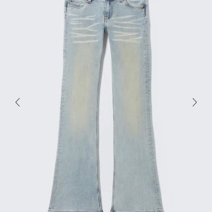 Bootcut ljusblå jeans med slitningar - säljer mina helt slutsålda Snygga bootcut byxor med låg midja från weekday,i storlek 25/32 helt oanvända då dem var för stora 