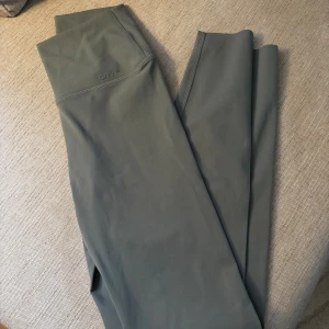 Grå / gröna leggings från Aim'n - Snygga grå / gröna leggings från Aim'n med hög midja och tight passform. Tillverkade i mjukt och stretchigt syntetmaterial som sitter skönt mot kroppen. Bara blivit provade men inte använda! 