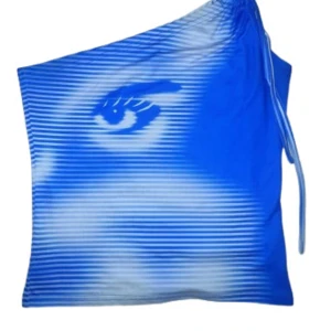 One-Shoulder Top (Eye Design) - 💙 One-shoulder topp i blått och vitt med ögonmotiv tryckt över hela framsidan 💙   Snörning finns vid axeln för justerbar passform. Toppen är gjord i mjukt och stretchigt material. Märke: Shein   Hör gärna av dig vid frågor eller med prisförslag! 💙🦋