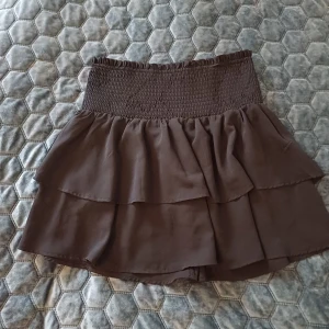 Svart kortkjol från C.W. - Supersöt svart kortkjol från C.W. med bred smock i midjan som ger en skön och flexibel passform. Kjolen är enkel och stilren, perfekt till toppar eller hoodies.Som känns lätt och luftig. Det är storlek S men aven om du har M kan du ha den ❤️