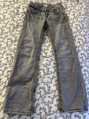 Grå low waste bootcut jeans - Säljer ett par grå jeans med bootcut från Ginatricot Young.Jeansen har low waste midja och är tillverkade i mjukt bomullsmaterial. Perfekta för en avslappnad och stilren look.
