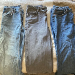 3 par jeans från Weekday & Gina Tricot - Säljer tre par jeans: ett par ljusblå 'perfect jeans' från Gina Tricot i storlek 36, ett par grå 'Rowe Extra High Straight Jeans' från Weekday i W27 L32 och ett par klassiska blå jeans. Alla har fem fickor, dragkedja och knappstängning. Perfekt för dig som gillar raka och tidlösa jeans.