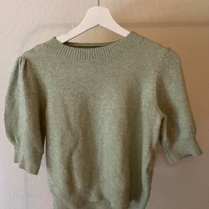 Ljusgrön stickad tröja med puffärm - Superfin ljusgrön stickad tröja med puffiga halvlånga ärmar och bred ribbad kant vid hals, ärmslut och nederkant.💕