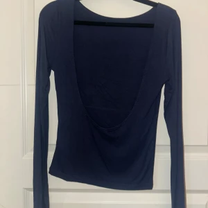 Mörkblå långärmad topp med öppen rygg - Säljer en mörkblå långärmad topp med öppen rygg. Använd en gång och är ifrån Gina i storlek M. 💙
