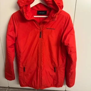 Röd vindjacka Peak Performance S - Säljer en röd/orange vindjacka från Peak Performance i storlek S. I gott skick. 