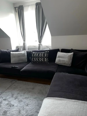 Stor fin L soffa  - En jätte fin L soffa som är svart/mörkgrå aktig pch har några skador på tyget på kudarna som man själv kan sy ihop ifall man årkar men de inget som syns så mycket till soffan tillkommer en rund pal vill sälja soffan snarast hör gärna av er för mer info 