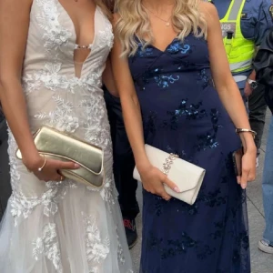 Marinblå glittrig balklänning med öppen rygg - Supersnygg marinblå balklänning med smala axelband och öppen rygg med snörning. Klänningen är täckt av glittriga paljetter och har en figurnära passform som ger en elegant siluett. Perfekt för bal eller festliga tillfällen när du vill sticka ut. Aldrig använd då den ej passade 🩷