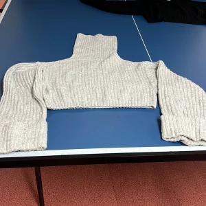 Grå ribbad polotröja från Gina Tricot - Säljer en snygg grå ribbad polotröja från Gina Tricot. Tröjan är croppad med långa ärmar och en hög polokrage..