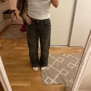 Svarta jeans med bootcut - Snygga svarta jeans med bootcut-stil. De har en klassisk design med fem fickor och en knappgylf. Perfekta för en avslappnad look.