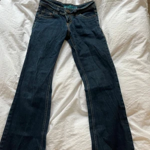 Mörkblå bootcut jeans - Snygga mörkblå bootcut jeans med låg midja. 