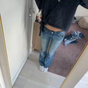 Blå jeans med bootcut - Jätte snygga lågmidjade jeans, totala längden är 100 cm, midjemått rakt över är 37cm och innerbens längd är ca 80cm💕