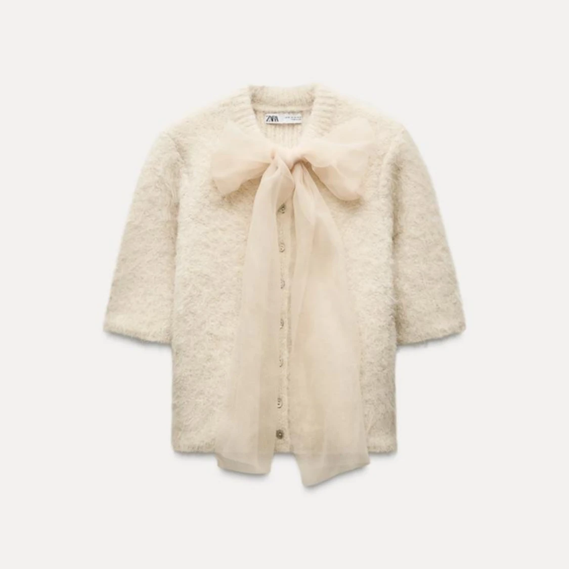 Vit kofta med stor rosett från Zara - 90