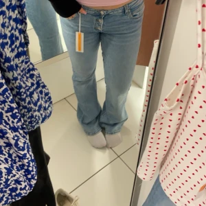 Blå jeans med bootcut - Snygga blå jeans med bootcut-stil och klassisk treknappsdesign. Perfekta för en avslappnad look. De har en normal passform och är tillverkade i ett bekvämt denimtyg. I strl 164 och passar mig som har S