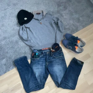 Grå merinoulltröja från Morris - Säljer en stilren grå tröja från Morris i 100% merinoull. Tröjan har en dragkedja vid halsen och en diskret logga på bröstet. Perfekt för kyligare dagar med sin mjuka och varma känsla. Storlek 164 isch