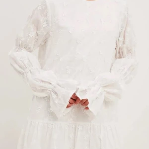 Vit blommig klänning med öppen rygg - Säljer denna vita klänning med öppen rygg. Med volang ärmar och blommigt mönster.💐 Perfekt till student/skolavslutning, eller bara för att ha till sommaren💗. Endast använd en gång. Nu säljer jag den då den blivit för kort. Nypris:799 kr