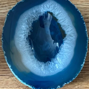 Blå agat sten - Vacker blå agat sten med en polerad yta och naturliga mönster. Stenen har en djup blå färg med vita detaljer som ger ett unikt utseende. Perfekt som dekoration eller samlarobjekt.