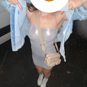 Glitter klänning nyår - Silvrig glitter klänning perfekt till nyår. Endast använd en gång. Säljer pga att den är för liten.