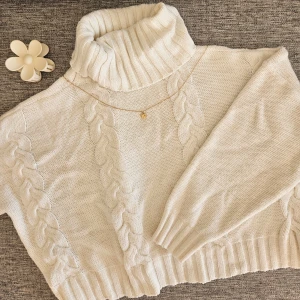 Vit stickad polotröja - Mysig vit stickad polotröja med flätmönster. Perfekt för kyliga dagar med sin höga krage och långa ärmar. En klassisk och stilren tröja för både vardag och fest 🤍