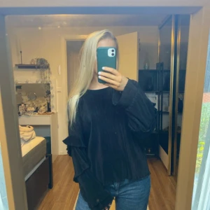 Svart ribbad blus/tröja - Säljer en svart tröja/blus i mycket bra skick. Den har en loose passform och långa ärmar, perfekt för höst och vinter. Tröjan är supermjuk och bekväm, idealisk för mysiga dagar hemma eller en avslappnad dag ute. Passar perfekt med jeans!