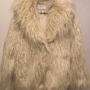 Pälsjacka strl M  - Pälsjacka i strl M från Bubbleroom. Kollektion: Madeleleine Bitici x Bubbleroom. - Något oversized modell. - Hysk- och hakestängning  - Fickor framtill  - Fodrad och fuskpäls   I nyskick, aldrig använd.